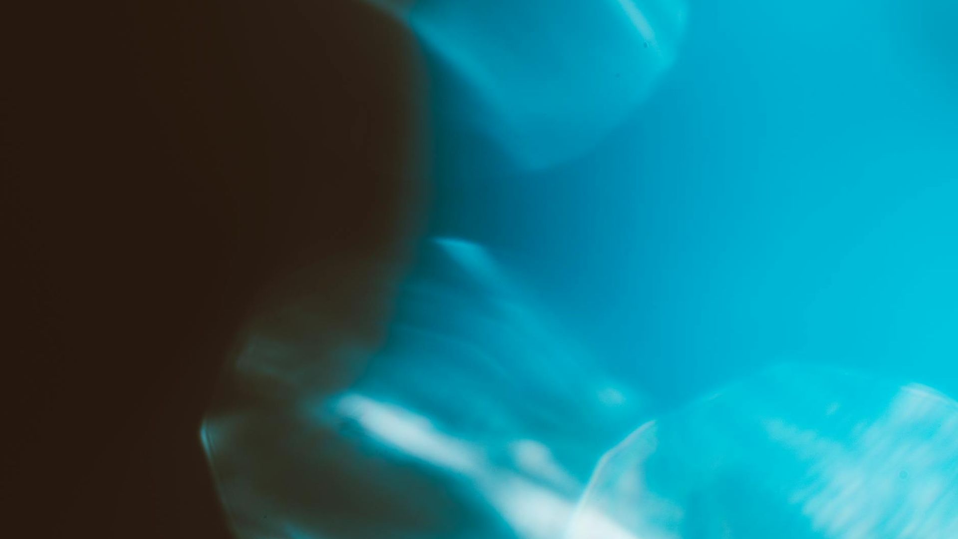 Abstract background with soft violet light waves representing calm and harmony.